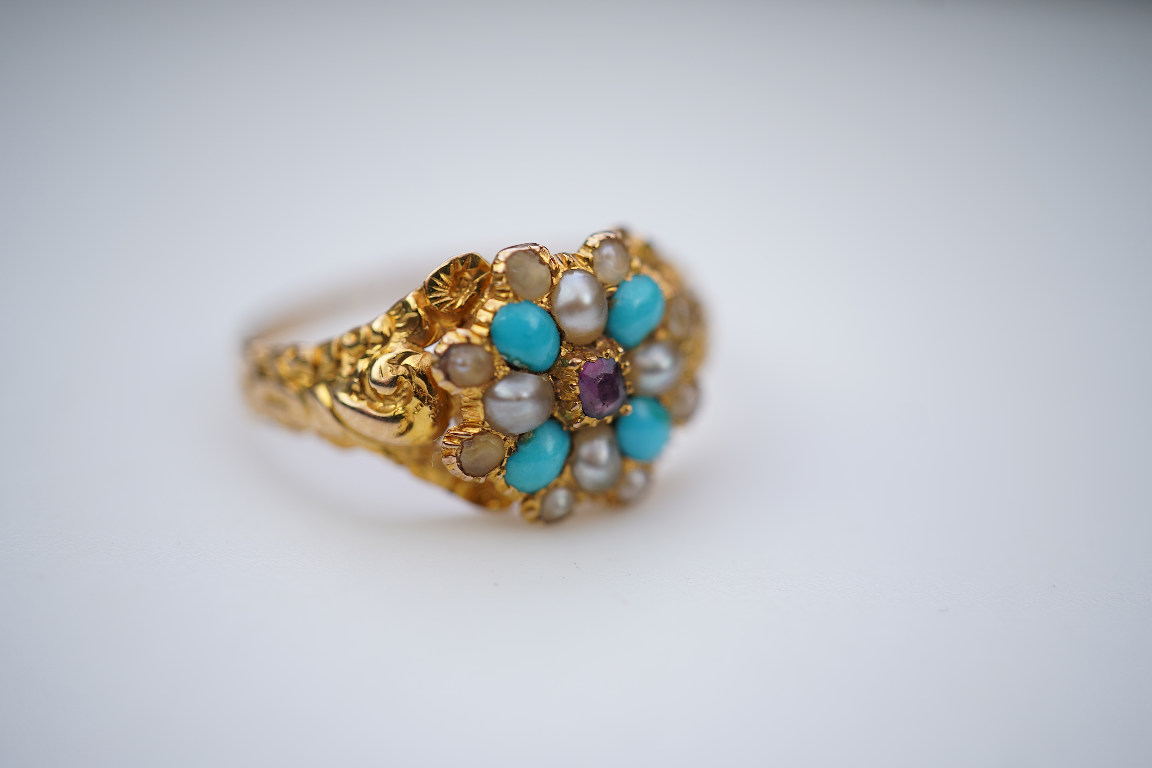 A late Georgian garnet, pearl and turquoise ring, circa 1830